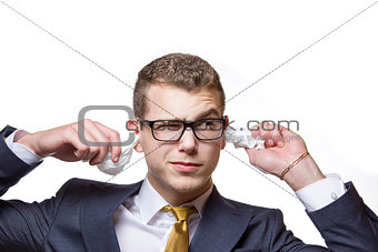 Young businessman cleaning his ears with a cotton tissue