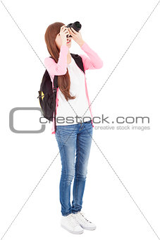 young girl taking a picture using digital camera