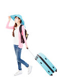 young woman holding  traveling case and hat