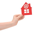 woman hand holding small red plastic house with email icon on wh