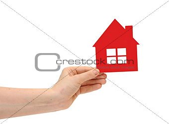 woman hand holding small red plastic house over white background
