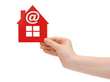 woman hand holding small red plastic house with email icon on wh