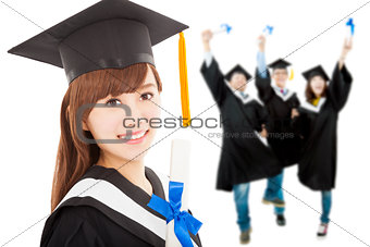Young graduate girl student holding  diploma with classmates