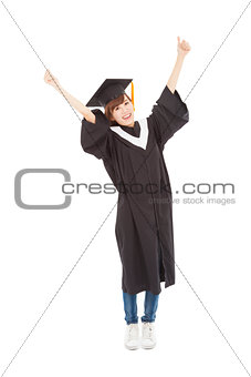 happy Young graduate girl student standing and hand up