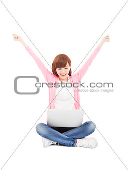 young woman online on a laptop computer and arms up