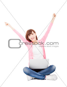 Happy young woman online with a laptop computer and arms up