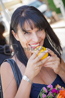 Pretty Italian Woman Smelling Oranges at the Street Market