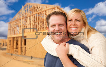 Couple in Front of New Home Construction Framing Site