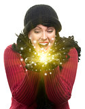 Excited Woman In Winter Clothes Holds Something Sparkling In Han