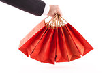 Man holding red shopping bags