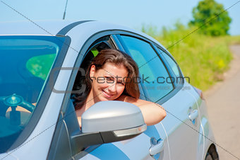 female driver looks out the car window