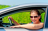 woman in sunglasses driving a modern car