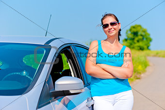 woman standing near his car on a country road