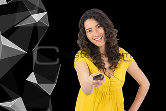 Composite image of smiling curly haired pretty woman changing channel with remote