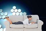 Composite image of business woman lying on couch