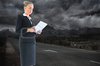 Composite image of businesswoman holding new tablet