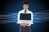 Composite image of businessman showing a laptop