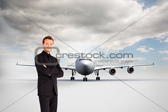 Composite image of handsome businessman with crossed arms