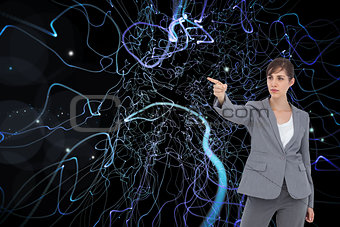 Composite image of young businesswoman pointing to something