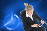 Composite image of businesswoman sitting on swivel chair with tablet