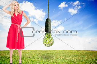 Composite image of elegant blonde standing hand on hip