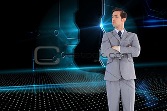 Composite image of serious businessman with arms crossed