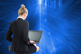 Composite image of businesswoman using laptop