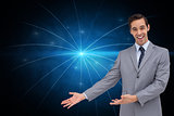 Composite image of happy businessman giving a presentation with his hands