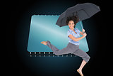 Composite image of happy classy businesswoman jumping while holding umbrella