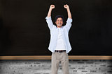 Composite image of cheering male with arms up