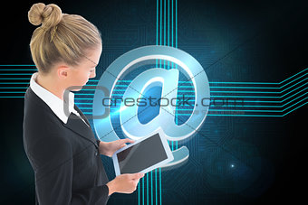 Composite image of businesswoman holding tablet