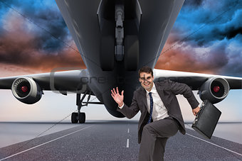 Composite image of happy businessman in a hury