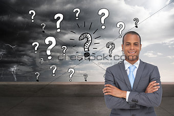 Composite image of charismatic young businessman with arms crossed