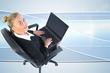 Composite image of businesswoman sitting on swivel chair with laptop