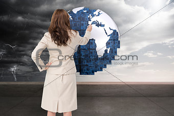 Composite image of businesswoman standing back to camera writing with marker