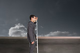 Composite image of happy businessman standing on ladder