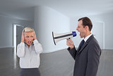 Composite image of businessman shouting at colleague with his bullhorn