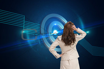Composite image of businesswoman standing back to camera with hand on head