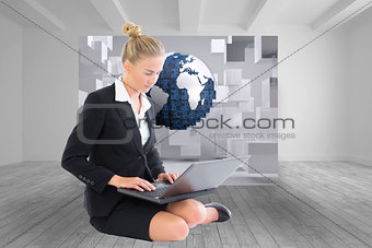 Composite image of businesswoman using laptop