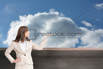 Composite image of smiling businesswoman raising her hand