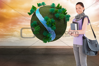 Composite image of attractive student holding books and her bag while standing
