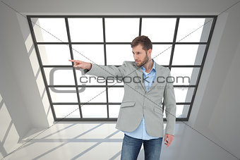 Composite image of trendy model pointing to something
