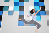 Composite image of happy classy businesswoman jumping while holding smartphone
