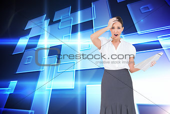 Composite image of shocked classy businesswoman holding newspaper