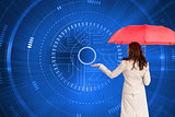 Composite image of businesswoman holding umbrella