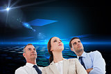 Composite image of serious work team posing together looking away