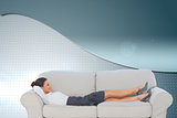 Composite image of smiling business woman lying down on the couch