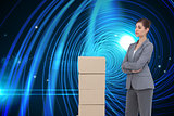 Composite image of thoughtful woman with cardboard boxes