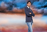 Composite image of unsmiling casual businessman with arms crossed
