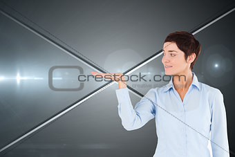 Composite image of businesswoman with an open hand to show a copy space